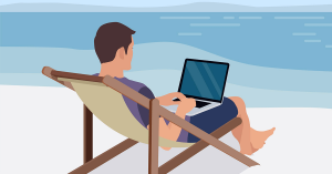 Guy on laptop sitting on the beach
